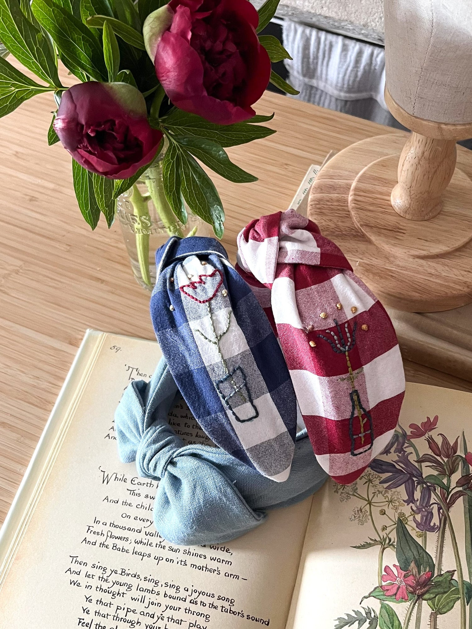 Three womens headbands on a vintage book with flowers